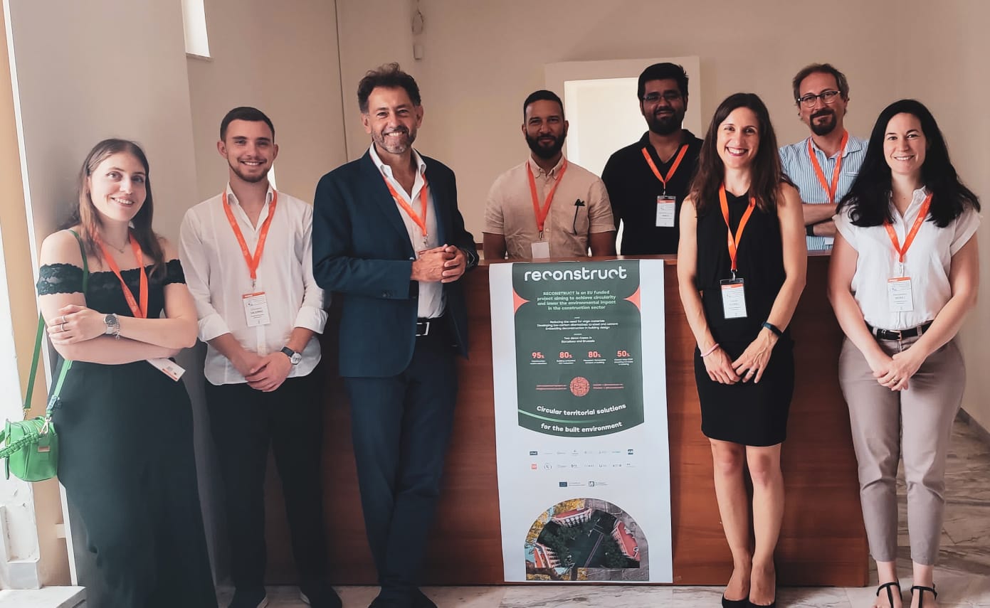 Group of RECONSTRUCT partners pose with the project banner