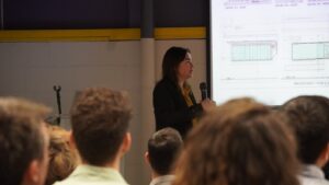 Person with microphone presenting during a meeting
