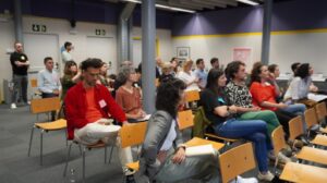 People sat on chairs listening to a presentation