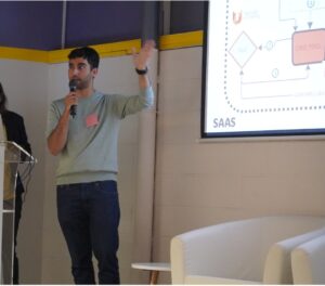Person speaking in front of a screen