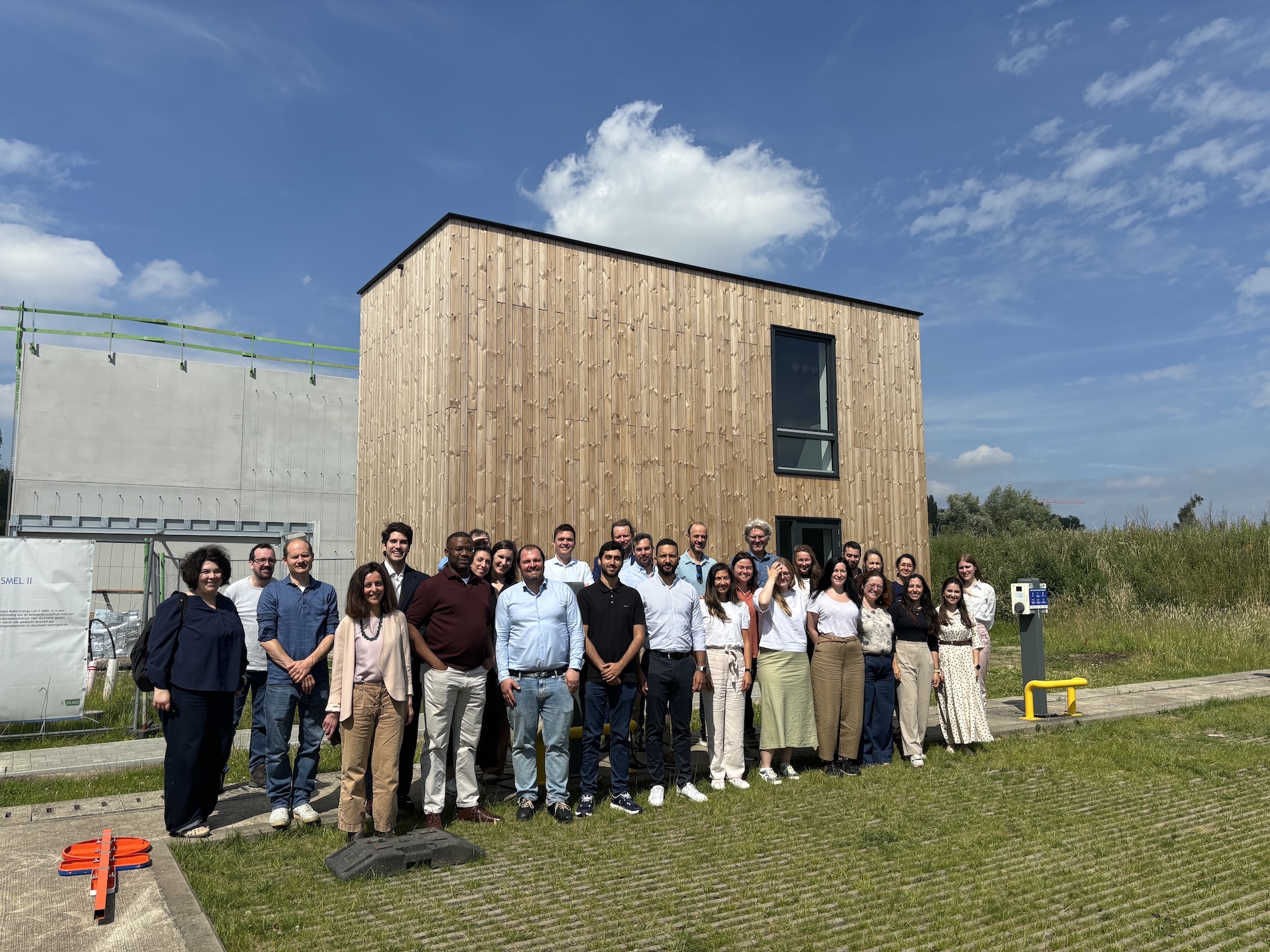 consortium group photo with Brussel demo building in the background